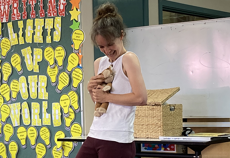 Tina Wilson with her children's book character Monkey presenting to a school
